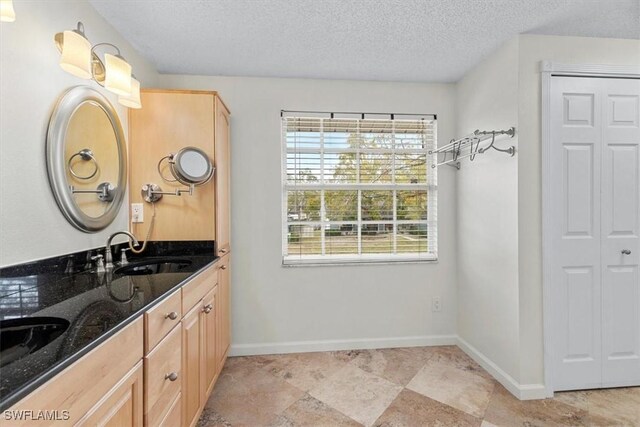 bathroom with vanity and a textured ceiling