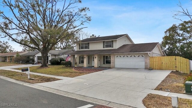 view of property featuring a garage and a front yard