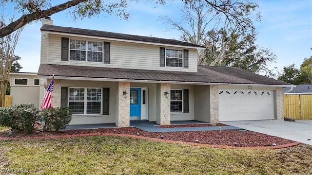 view of front of house with a garage and a front lawn