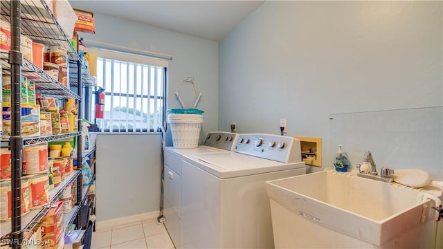 laundry area with light tile patterned flooring, sink, and washer and dryer