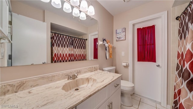 bathroom with tile patterned flooring, vanity, toilet, and walk in shower