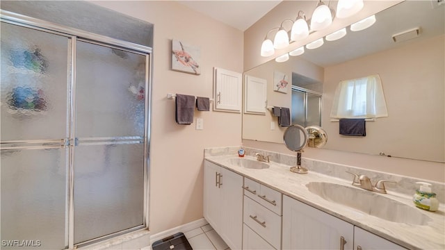 bathroom featuring walk in shower, vanity, and tile patterned flooring