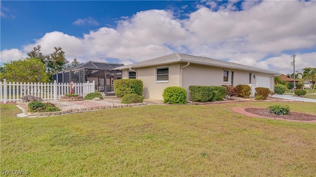 view of front of house with a garage, glass enclosure, and a front yard