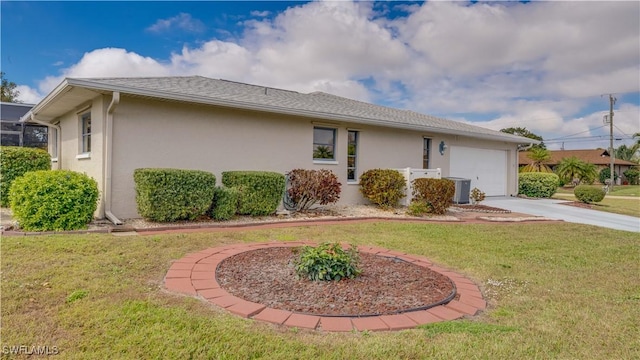 view of property exterior featuring a garage, a lawn, and central air condition unit