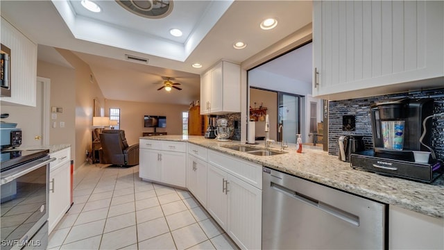 kitchen featuring sink, white cabinetry, dishwasher, light stone countertops, and stove