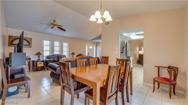 dining area with light tile patterned floors, ceiling fan with notable chandelier, and vaulted ceiling