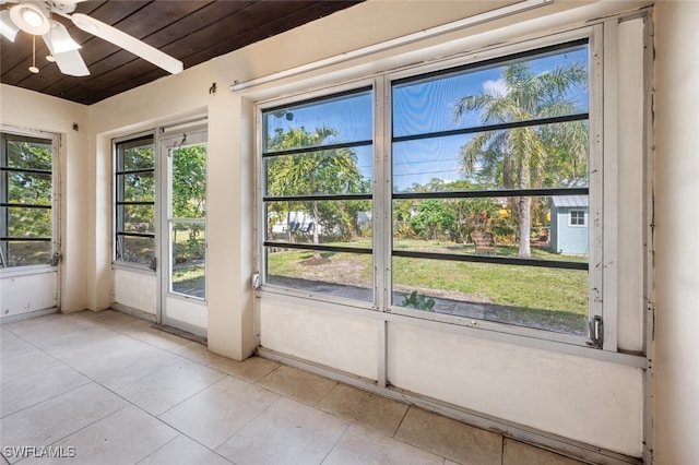 unfurnished sunroom with wooden ceiling and ceiling fan