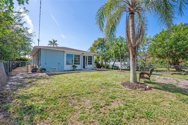 rear view of property with a yard