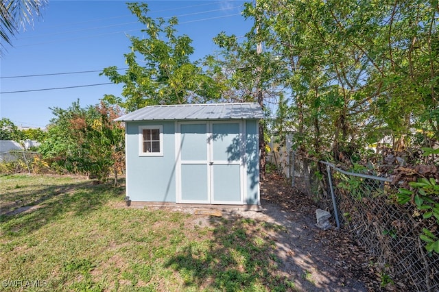 view of outbuilding with a lawn