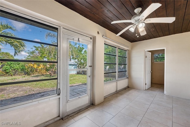 doorway with wood ceiling, ceiling fan, and light tile patterned floors