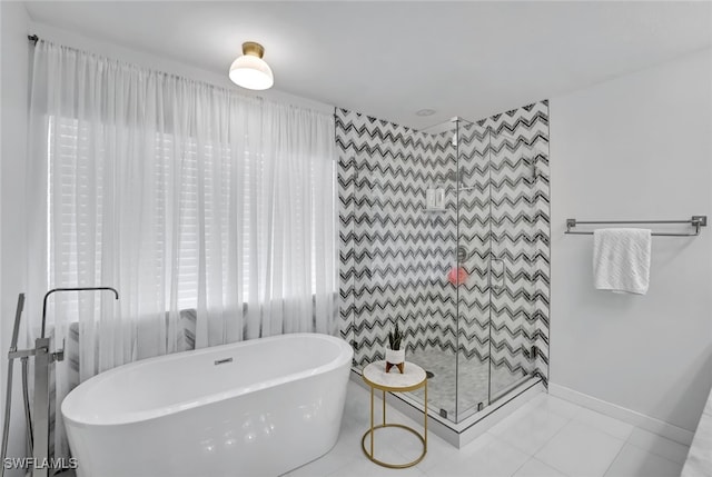 bathroom featuring independent shower and bath and tile patterned flooring