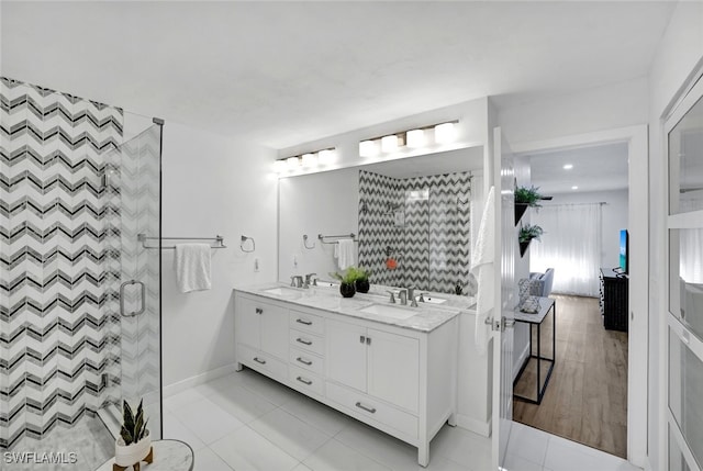 bathroom with vanity, tile patterned flooring, and a shower with door