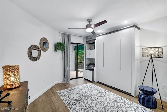 bedroom featuring access to outside, light hardwood / wood-style floors, and ceiling fan