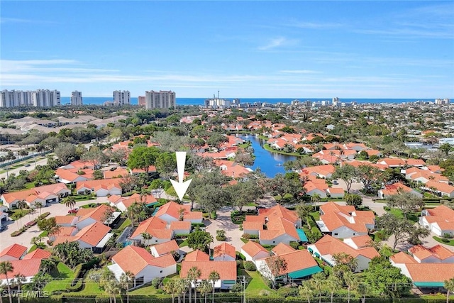 birds eye view of property featuring a water view, a city view, and a residential view