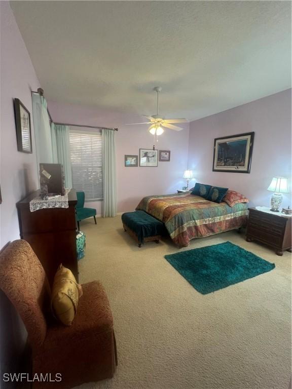 carpeted bedroom featuring a ceiling fan