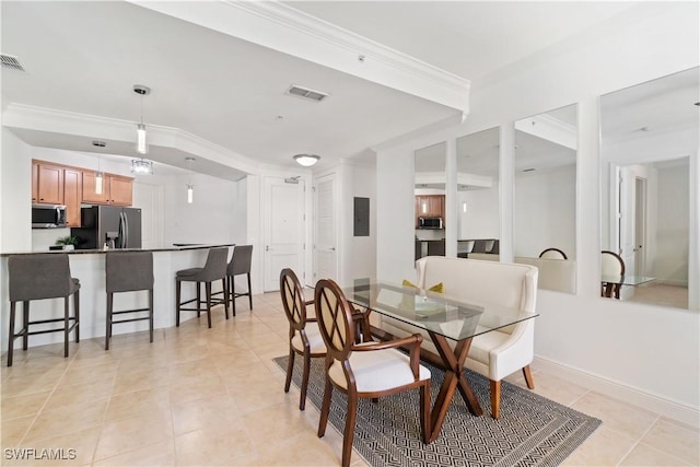 tiled dining area with crown molding and electric panel