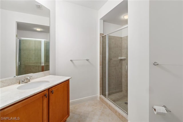 bathroom with vanity, tile patterned floors, and walk in shower