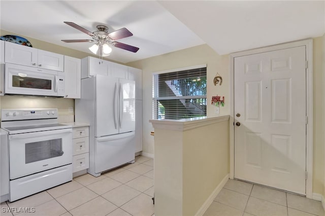 kitchen featuring light tile patterned floors, white appliances, white cabinets, and ceiling fan