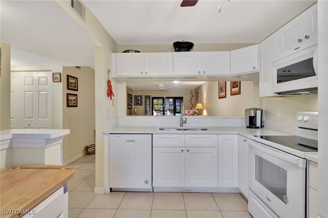 kitchen featuring light tile patterned flooring, sink, white cabinetry, ceiling fan, and white appliances