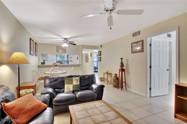 tiled living room with ceiling fan