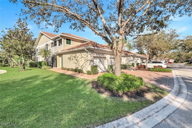 view of side of home featuring a garage and a yard