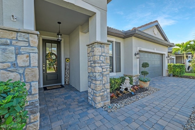 view of exterior entry with a garage