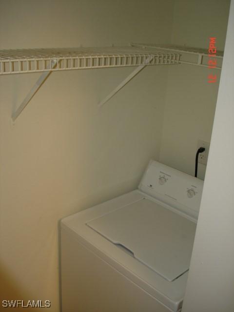 clothes washing area with washer / dryer