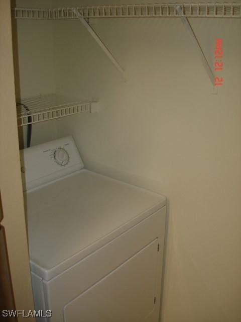 clothes washing area with washer / clothes dryer