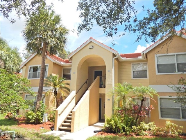 12571 Equestrian Cir Unit 902, Fort Myers, FL 33907 - view of front of house with stucco siding and stairway