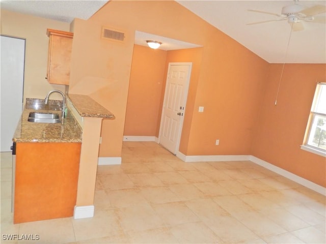 12571 Equestrian Cir Unit 902, Fort Myers, FL 33907 - kitchen with light stone counters, ceiling fan, light tile patterned floors, and lofted ceiling
