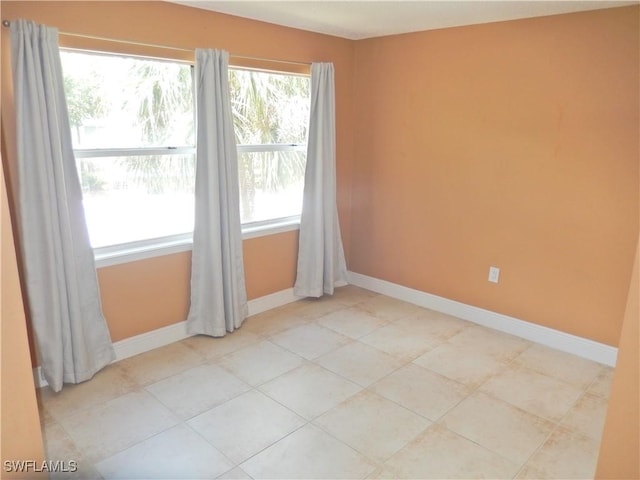 12571 Equestrian Cir Unit 902, Fort Myers, FL 33907 - spare room with baseboards and light tile patterned flooring