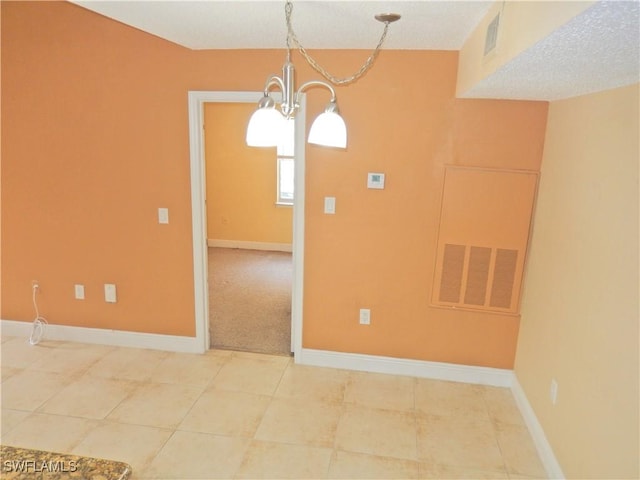 12571 Equestrian Cir Unit 902, Fort Myers, FL 33907 - tiled spare room featuring a chandelier and baseboards