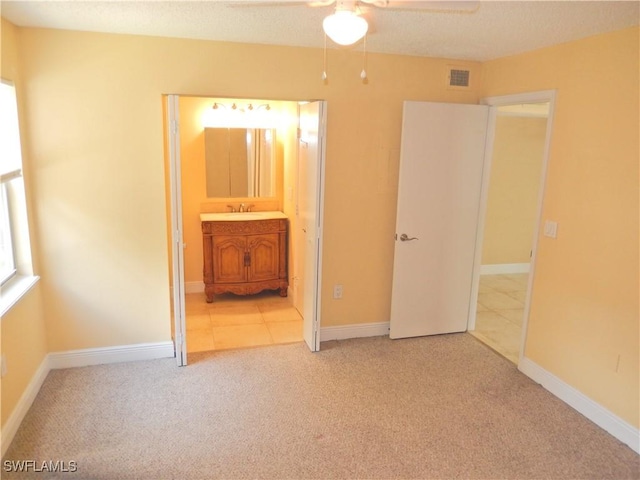 12571 Equestrian Cir Unit 902, Fort Myers, FL 33907 - unfurnished bedroom featuring light colored carpet, connected bathroom, and a textured ceiling