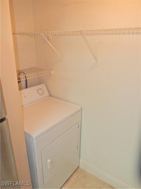 12571 Equestrian Cir Unit 902, Fort Myers, FL 33907 - washroom with washer / dryer and baseboards