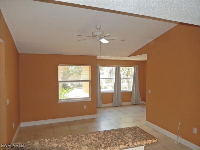 12571 Equestrian Cir Unit 902, Fort Myers, FL 33907 - spare room featuring a ceiling fan, light tile patterned floors, and vaulted ceiling