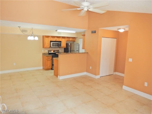 12571 Equestrian Cir Unit 902, Fort Myers, FL 33907 - kitchen featuring appliances with stainless steel finishes, ceiling fan, brown cabinets, a peninsula, and stone counters
