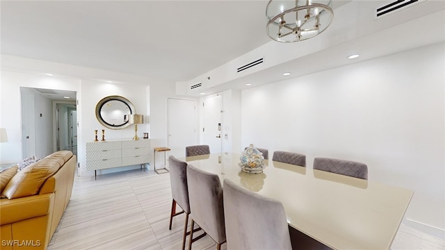 tiled dining space featuring an inviting chandelier