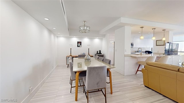 dining room with sink and a notable chandelier