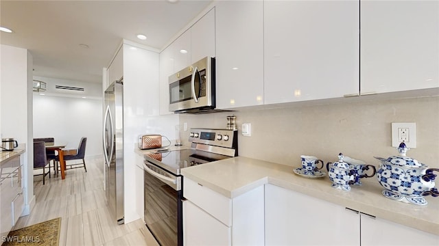 kitchen with white cabinetry and appliances with stainless steel finishes