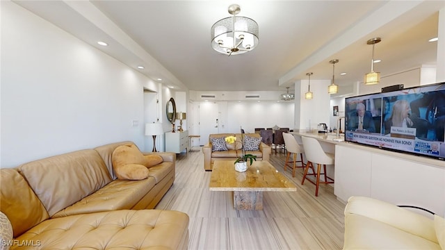 living room with light hardwood / wood-style flooring and a chandelier