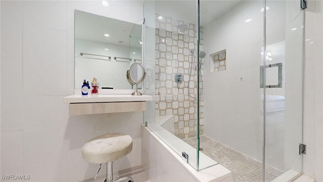 bathroom featuring tile walls and a shower with door