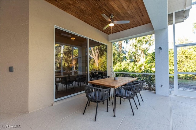 sunroom featuring lofted ceiling, wood ceiling, and ceiling fan