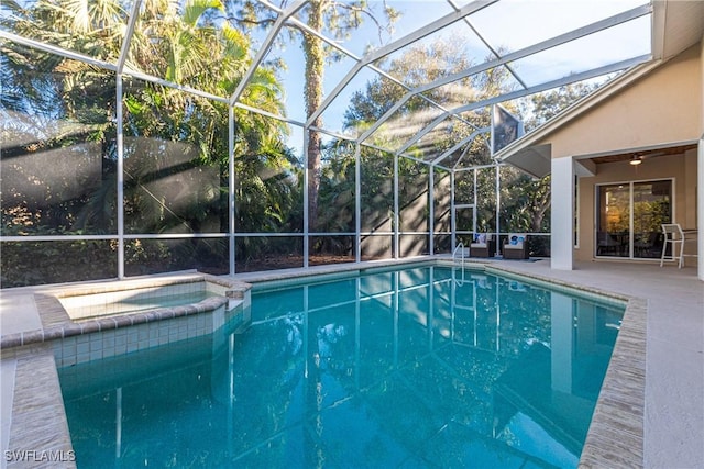 view of pool featuring an in ground hot tub, a lanai, and a patio area