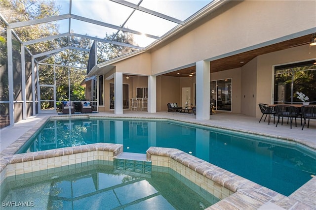 view of swimming pool featuring a patio, a lanai, and ceiling fan