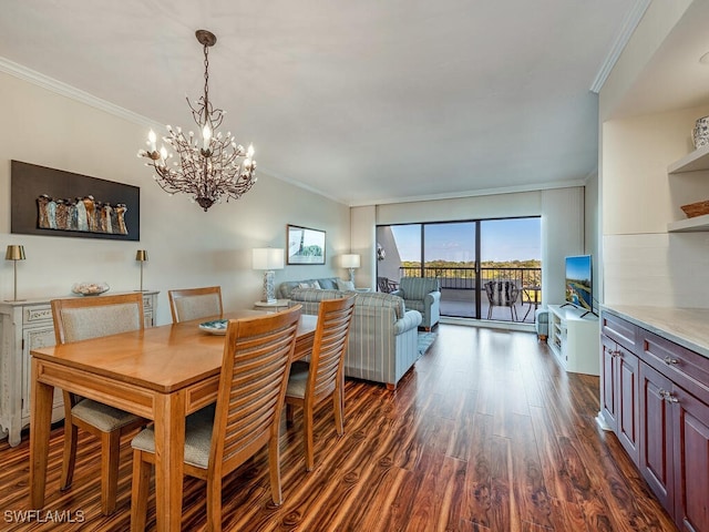 dining area featuring crown molding, dark wood-type flooring, and a chandelier