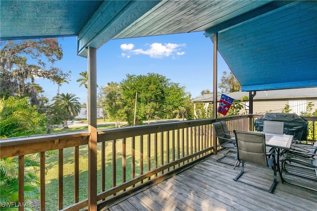 wooden deck with area for grilling and a yard