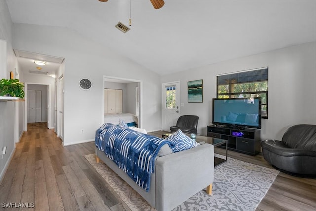 living room featuring lofted ceiling, hardwood / wood-style floors, and ceiling fan