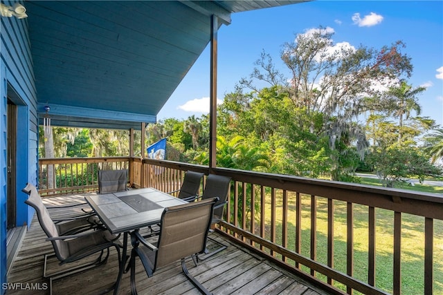 wooden terrace featuring a yard