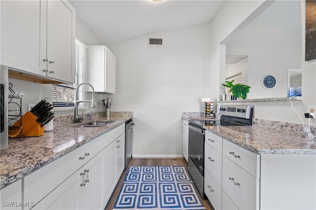 kitchen featuring appliances with stainless steel finishes, light stone countertops, sink, and white cabinets