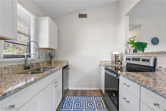 kitchen featuring white cabinetry, appliances with stainless steel finishes, light stone countertops, and sink